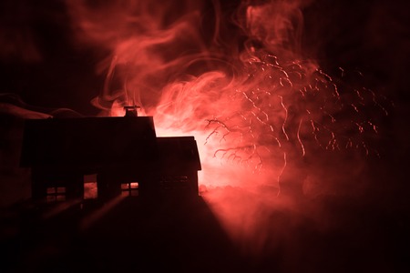 Old house with a Ghost at night with spooky tree or Abandoned Haunted Horror House in toned foggy...