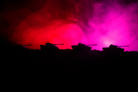 War Concept. Military silhouettes fighting scene on war fog sky background, World War German Tanks Silhouettes Below Cloudy Skyline At night. Attack scene. Armored vehicles. Tanks battleの写真素材