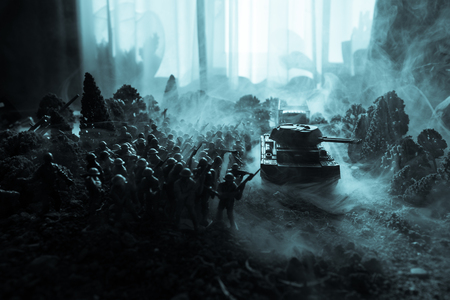 War Concept. Military silhouettes fighting scene on war fog sky background, World War Soldiers Silhouettes Below Cloudy Skyline. Armored vehicles. Tanks battle. Decoration. Selective focusの写真素材