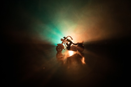 High power motorcycle chopper. Fog with backlights on background with man rider at night. Empty...