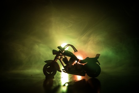 High power motorcycle chopper. Fog with backlights on background with man rider at night. Empty space. Selective focusの写真素材
