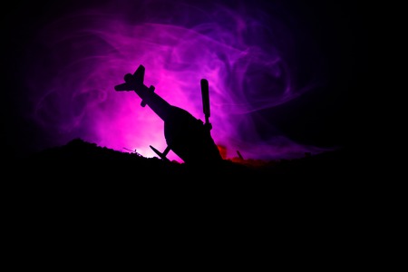 Air Crash. Burning falling helicopter. Destroyed helicopter. Decorated with toy at dark fire background. War conceptの写真素材