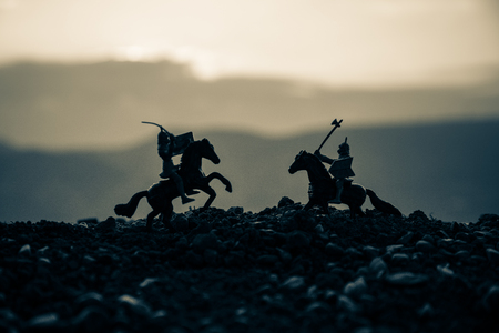 Joust between two knights on horseback. Sunset on background.の写真素材