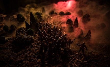 War Concept. Military silhouettes fighting scene on war fog sky background, World War Soldiers Silhouettes Below Cloudy Skyline At night. Attack scene. Armored vehicles. Selective focus. Decorationの写真素材