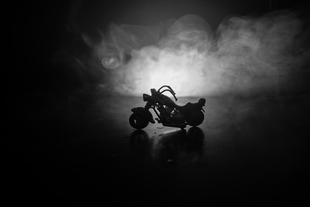 High power motorcycle chopper. Fog with backlights on background with man rider at night. Empty space. Selective focusの写真素材