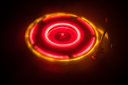 Music concept. Freezelight glowing vinyl on dark background or Turntable playing vinyl with glowing abstract lines concept on dark background. For Club poster Designの写真素材