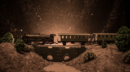 Train moving in fog. Ancient steam locomotive in night. Night train moving on railroad. toned foggy fire background. Horror mystical scene. Selective focusの写真素材