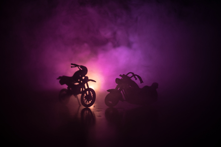High power motorcycle chopper. Fog with backlights on background with man rider at night. Empty space. Selective focusの写真素材