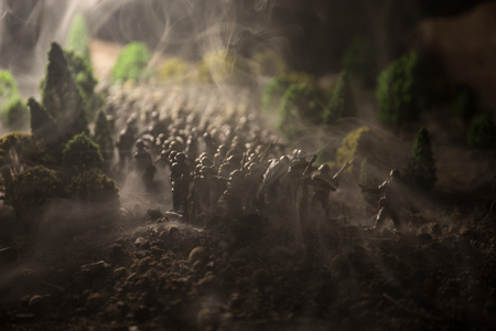 War Concept. Military silhouettes fighting scene on war fog sky background, World War Soldiers Silhouettes Below Cloudy Skyline. Armored vehicles. Tanks battle. Decoration. Selective focusの写真素材