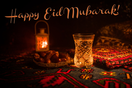 Water and dates. Iftar is the evening meal. View of decoration Ramadan Kareem holiday on carpet. Festive greeting card, invitation for Muslim holy month Ramadan Kareem. Selective focusの写真素材