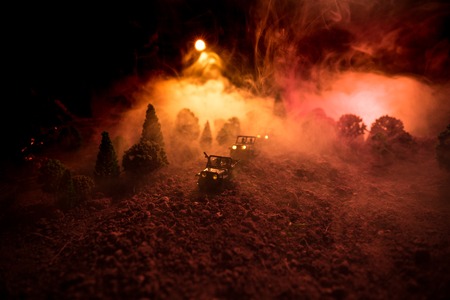 War Concept. Military silhouettes fighting scene on war fog sky background, World War Soldiers Silhouettes Below Cloudy Skyline At night. Attack scene. Armored vehicles. Selective focus. Decorationの写真素材