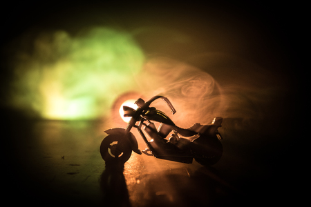 High power motorcycle chopper. Fog with backlights on background with man rider at night. Empty space. Selective focusの写真素材