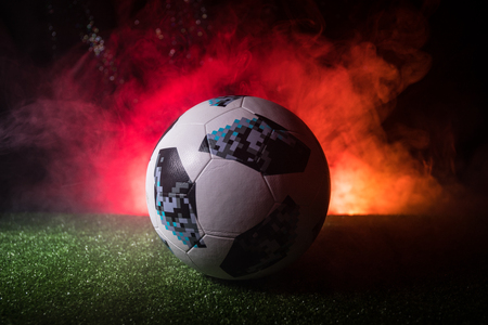 BAKU,AZERBAIJAN - JUNE 21, 2018 : Creative concept. Official Russia 2018 World Cup football ball The Adidas Telstar 18 on green grass with dark toned foggy background. Selective focusのeditorial素材