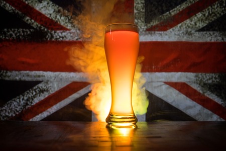 Soccer 2018. Single beer glass on table at dark toned foggy background. Support England with beer concept. Selective focusの写真素材