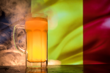 Soccer 2018. Single beer glass on table at dark toned foggy background. Support Belgium with beer concept. Selective focusの写真素材