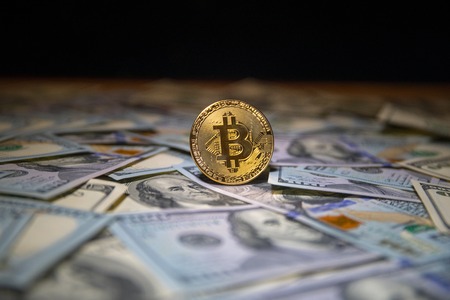 Bitcoin (New virtual money) coin on us dollars close up selective focus. Digital Money and Bitcoin Concept.の写真素材