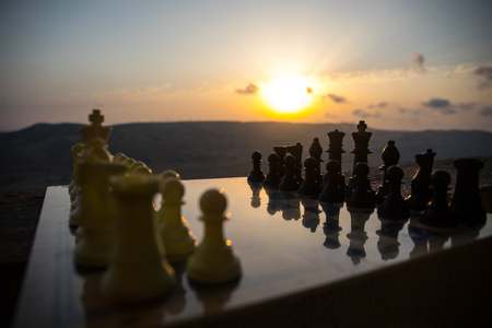 chess board game concept of business ideas and competition and strategy ideas. Chess figures on a chessboard outdoor sunset background. Selective focusの写真素材
