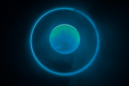 Music concept. Freezelight glowing vinyl on dark background or Turntable playing vinyl with glowing...