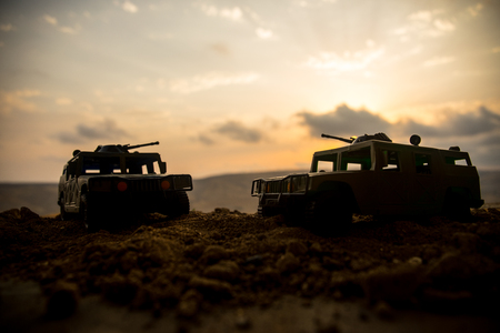 War Concept. Military silhouettes fighting scene on war fog sky background, World War Soldiers Silhouettes Below Cloudy Skyline at sunset. Attack scene. Armored vehicles. tank in actionの写真素材