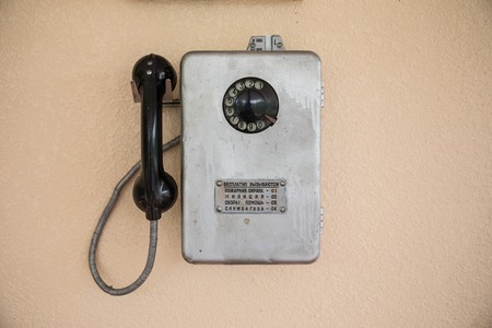 Old retro phone on a wall of gray. Selective focusの写真素材