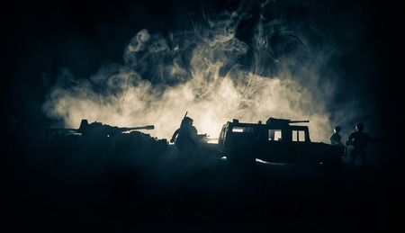 War Concept. Military silhouettes fighting scene on war fog sky background, Fighting silhouettes Below Cloudy Skyline At night. Battle scene. Army jeep vehicle with soldiers. army jeepの写真素材