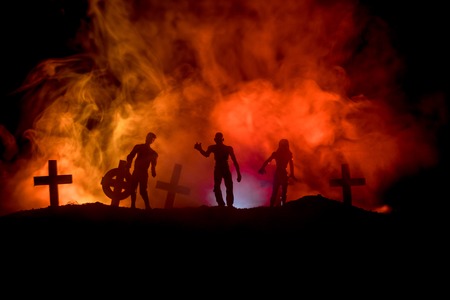 Scary view of zombies at cemetery dead tree, moon, church and spooky cloudy sky with fog, Horror...