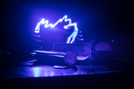 Energy for mining cryptocurrency. The energy meter with bitcoin and money on dark toned foggy background. Power Counter Meter Voltage Measuring Outlet Power consumption of Mining Rig. Selective focusの写真素材