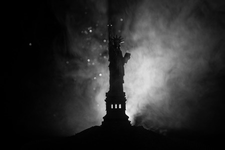 Silhouette statue of liberty on dark toned foggy background.の写真素材