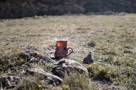 Eastern black tea in glass outdoor mountains background.の写真素材