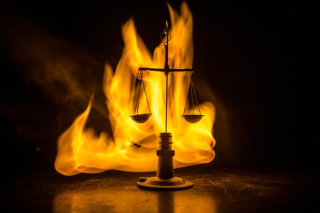 Justice scale with dark toned foggy background. Justice concept. Scale is symbol of justice. Selective focusの写真素材