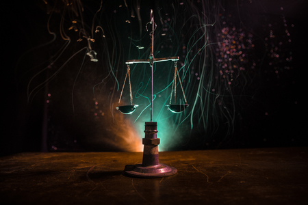 Justice scale with dark toned foggy background. Justice concept. Scale is symbol of justice. Selective focusの写真素材