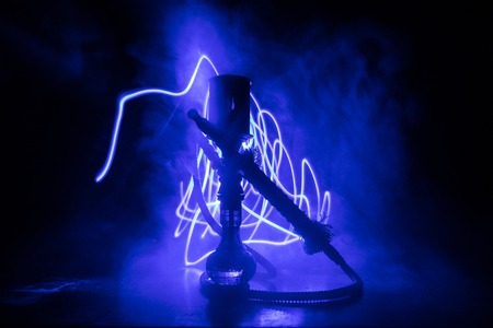 Hookah hot coals on shisha bowl making clouds of steam. Shisha explosion. Stylish oriental shisha in dark with fire. For Shisha advertisement. Burning shisha conceptの写真素材