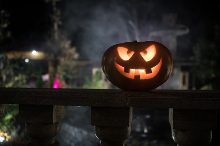 Halloween pumpkin. Carved Halloween pumpkin glowing in the dark. Outdoor shotの写真素材