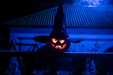 Halloween pumpkin. Carved Halloween pumpkin glowing in the dark. Outdoor shot