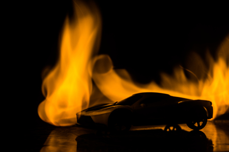 The car in the shadows with glowing lights in low light, or silhouette of sport car dark background. Selective focusの写真素材