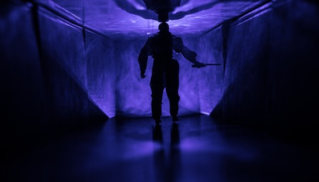 Creepy silhouette in the dark abandoned building. Horror about maniac concept or Dark corridor with cabinet doors and lights with silhouette of spooky horror person standing with different poses.の写真素材