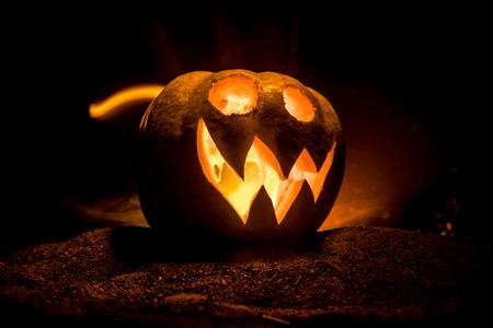 Halloween pumpkin smile and scrary eyes for party night. Close up view of scary Halloween pumpkin...