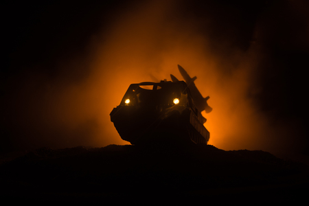 Rocket launch with fire clouds. Battle scene with rocket Missiles with Warhead Aimed at Gloomy Sky at night. Rocket vehicle on War Backgound. Selective focusの写真素材