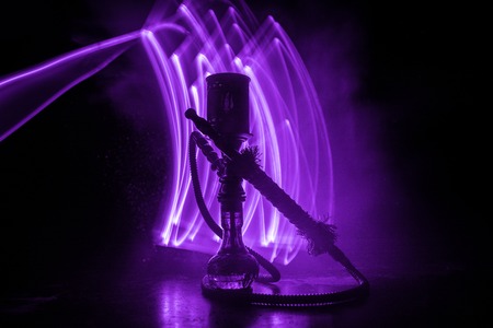 Hookah hot coals on shisha bowl making clouds of steam. Shisha explosion. Stylish oriental shisha in dark with fire. For Shisha advertisement. Burning shisha conceptの写真素材