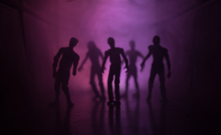 Creepy silhouette in the dark abandoned building. The zombie apocalypse concept or Dark corridor with silhouettes of spooky horror zombies standing with different poses.の写真素材