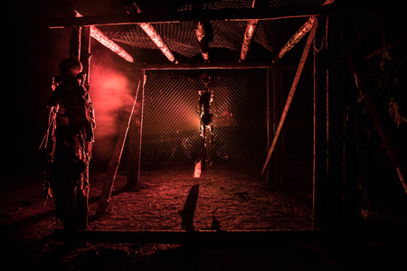 Horror view silhouette of hanged man on scaffold at night with fog and toned light on background. Execution (or suicide) decoration. Horror Halloween concept.の写真素材
