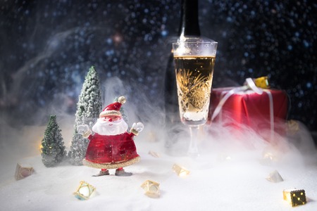 Glass of champagne with Christmas decoration. Traditional winter holiday alcohol drink in snow with creative New Year artwork. Copy spaceの写真素材