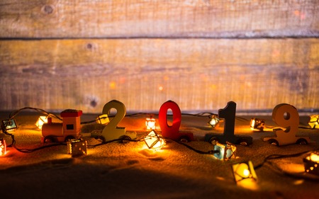 2019 happy new year,wooden toy train carrying numbers and Cristmas tree,covering snow. Holiday...
