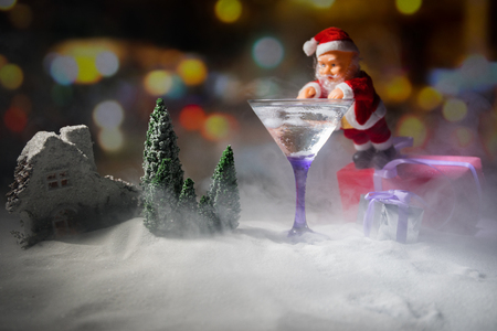 Winter Cocktail - Alcoholic drink and snow scene with a Christmas theme or Ideas and recipes for Christmas drink. Glass of martini on snow with Christmas decoration, copy spaceの写真素材