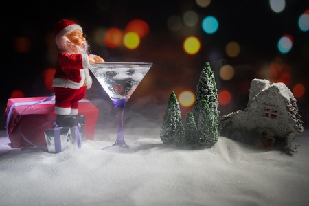 Winter Cocktail - Alcoholic drink and snow scene with a Christmas theme or Ideas and recipes for Christmas drink. Glass of martini on snow with Christmas decoration, copy spaceの写真素材