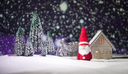 Festive background. Christmas decorations. Santa Claus  standing on snow with beautiful decorated background with holiday elements. Selective focus. Empty space for your textの写真素材
