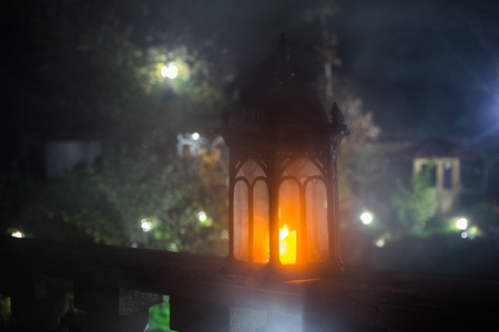 Retro style lantern at night. Beautiful colorful illuminated lamp at the balcony in the garden. Selective focusの写真素材