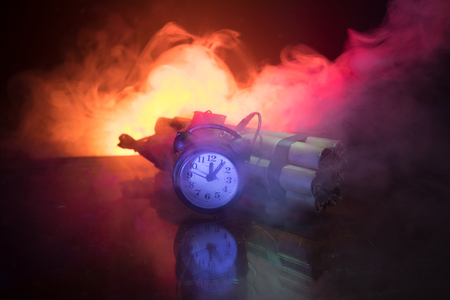 Image of a time bomb against dark background. Timer counting down to detonation illuminated in a shaft light shining through the darkness, conceptual imageの写真素材