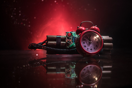 Image of a time bomb against dark background. Timer counting down to detonation illuminated in a...