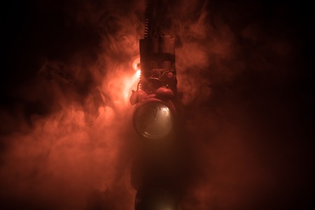 Image of a time bomb against dark background. Timer counting down to detonation illuminated in a shaft light shining through the darkness, conceptual imageの写真素材